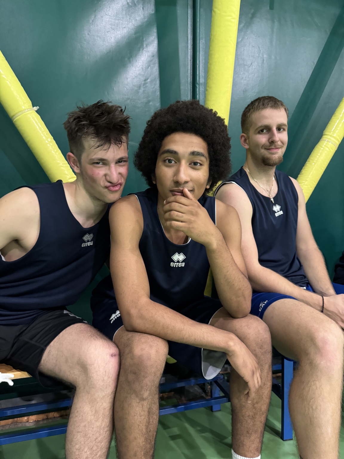 Three CUS Padova teammates sitting together on the bench.